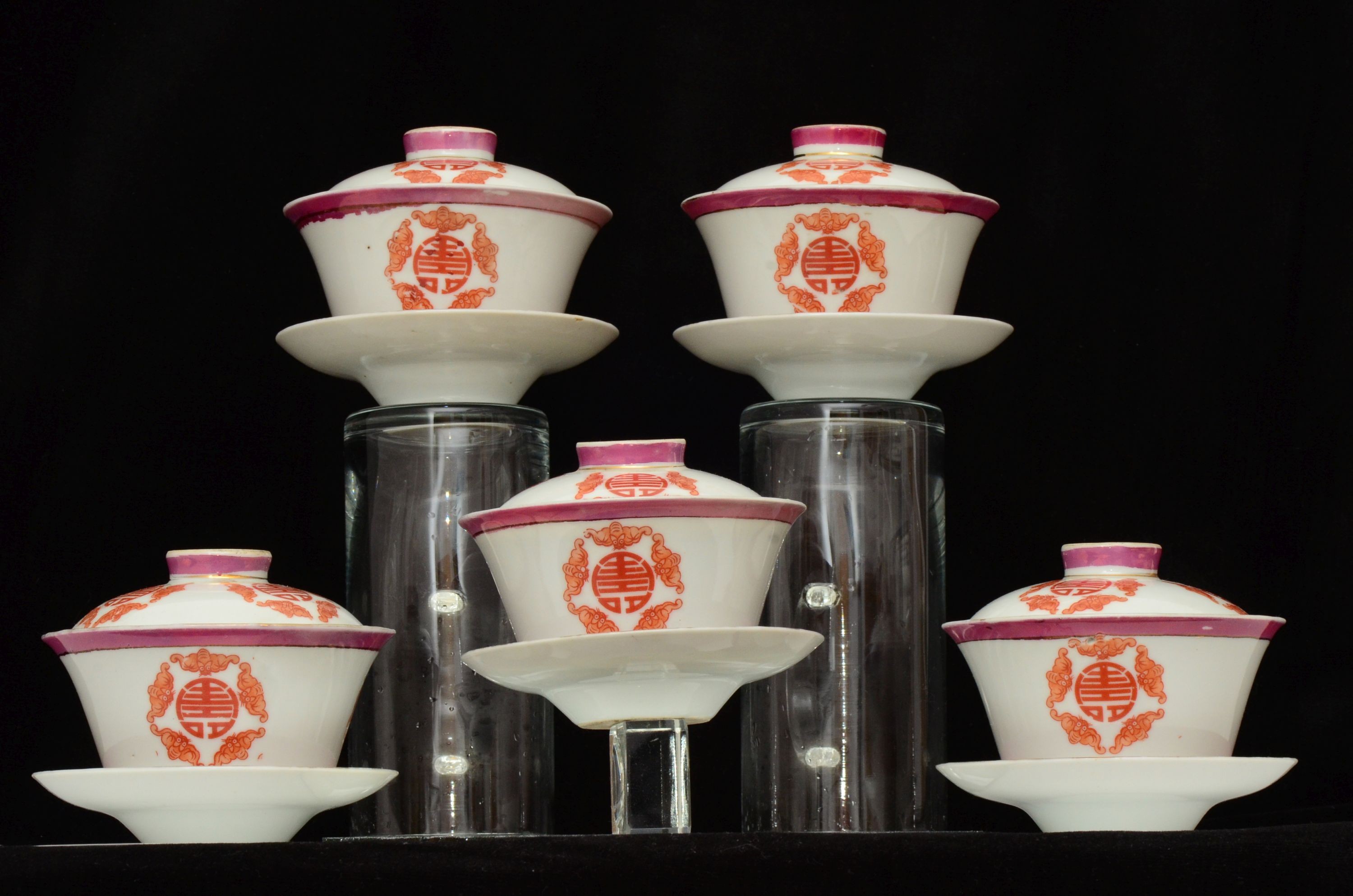 A set of five Chinese teabowls, covers and stands and a similar 'dragon' vase, 23cm